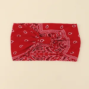 Detail of red paisley wide headband with bohemian knot design and elastic fabric