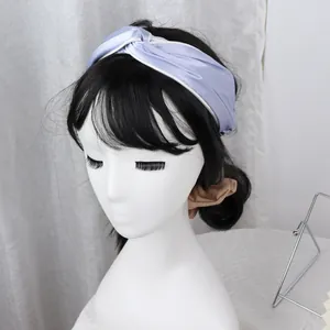 Crossed light purple satin headband with white piping on a female model with black hair