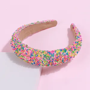 Detail of candy-colored sponge headband with vibrant sprinkle-like colorful decorations