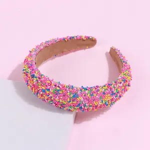 Detailed view of thick sponge headband with colorful candy sprinkle decorations