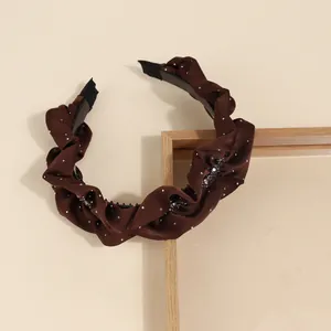 Brown satin pleated headband with sparkling crystal accents and silver rhinestone embellishment