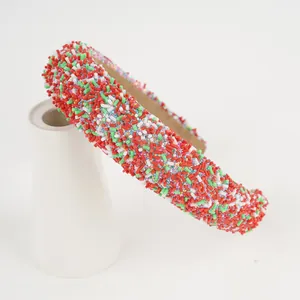 Close-up of colorful candy sprinkle headband on a white ceramic display stand
