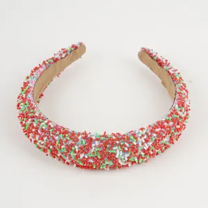 Detail of red, green, and white bead texture on a high-top sponge Christmas headband