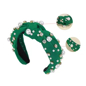 Vintage green knotted headband with baroque pearls and rhinestones on white background