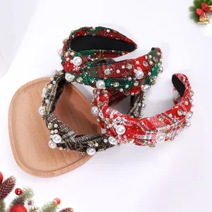 Detail of three Christmas knotted headbands with pearls and rhinestones on festive decor