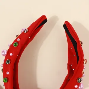 Detailed macro view of red baroque headband showing pink pearls and colorful rhinestones
