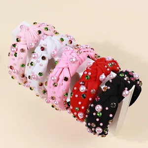 Macro detail of 5-piece velvet knot headbands with colorful rhinestones and pearls