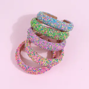 Five candy-colored sponge headbands with sparkling sequins and padded high-top design