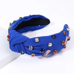 Detail of blue knotted headband with American flag charms and colorful rhinestones