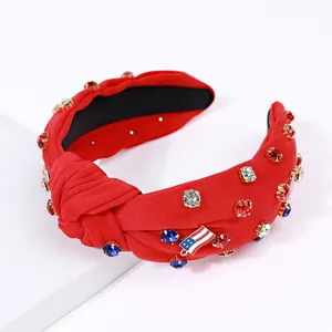 Detail of red knotted headband featuring American flag charm and colorful rhinestones