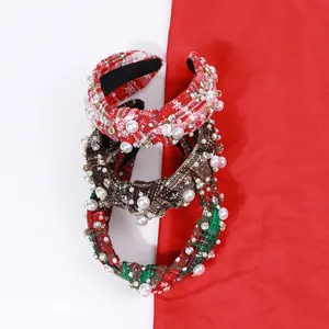 Detailed view of red and green plaid knot headbands with pearls and crystals decoration
