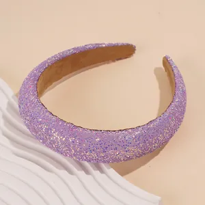 Detail of purple glitter padded headband with sparkling sequins on a white display tray