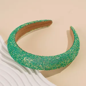 Detail view of thick green sequin headband with soft gold glitter and non-slip lining