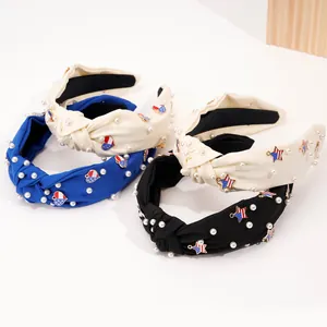 Close-up of fabric headbands with faux pearls and USA flag themed metal charms