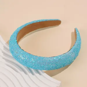 Detail shot of light blue padded headband with shiny glitter texture and soft fabric lining