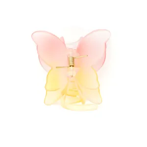 Détail de la pince à cheveux papillon avec dégradé rose et jaune et ressort doré