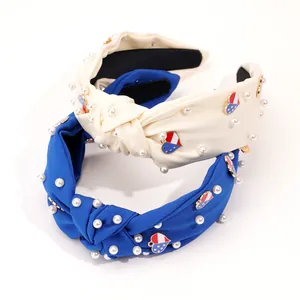 Detail of fabric knotted headbands with white pearls and US flag heart pendants