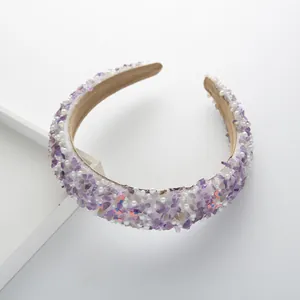 Close-up of purple stone and pearl headband with comfortable soft velvet lining