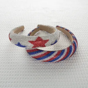 Detailed close-up of wide padded headbands with red, blue, and silver rhinestone patterns