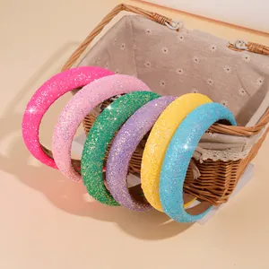 Set of six colorful sequin headbands in a woven basket for creative girl hair styling