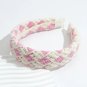 Detail of pink and white checkered crochet headband featuring soft knit texture