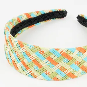 Close-up of colorful raffia headband with woven texture and black non-slip inner lining