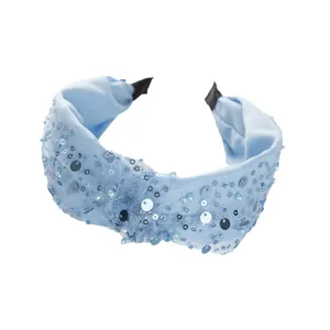 Cerchietto annodato azzurro con paillettes scintillanti e decorazioni di perle eleganti