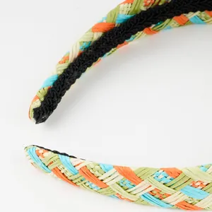 Detail of colorful hand-woven raffia headband showing texture and non-slip lining