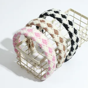 Close-up of three crochet knit headbands in colorful plaid patterns with soft texture