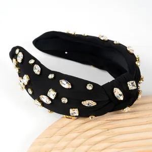 Macro shot of knots and sparkling rhinestones on luxury black fabric headband
