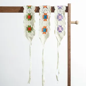 Detailed knit texture of handmade crochet flower headbands on a wooden display