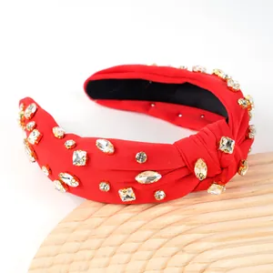 Sparkly red knotted headband with rhinestones for a high-volume hair look and party style