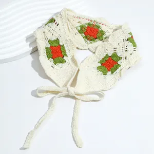 Detail of crochet floral headscarf with granny square pattern and beige ties