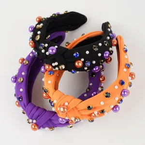 Detail of three knotted headbands with pearls and colorful rhinestones for Halloween party