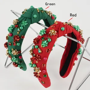 Detail of Christmas knotted headband with festive beads, red rhinestones and bow accents