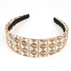 Macro view of woven raffia headband showing beige checkered pattern and non-slip lining
