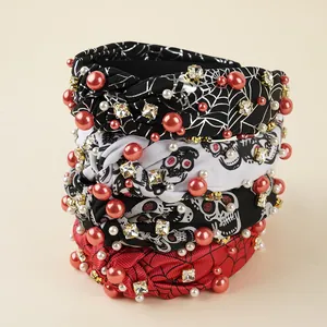 Detail of Halloween knot headbands with rhinestones, pearls, and spider web prints