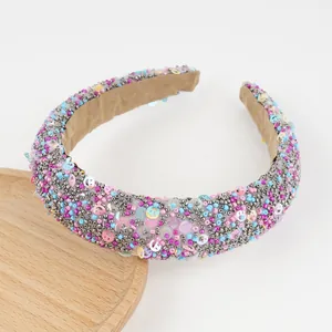 Close-up of colorful beads and sequin smiley faces on a padded wide headband