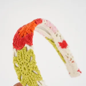 Detailed close-up of bohemian crochet headband with colorful floral knit patterns