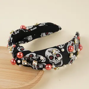 Halloween knot headband with skull patterns, red pearls, and rhinestones on black fabric
