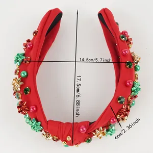 Detailed view of red Christmas knotted headband with festive beads, bows and size labels