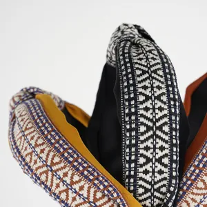 Macro shot of ethnic embroidery patterns and textured woven fabric on wide hairbands