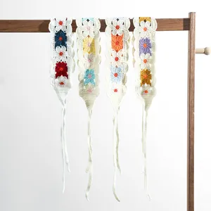 Detail of colorful crochet flower headbands showing intricate handmade knitting texture
