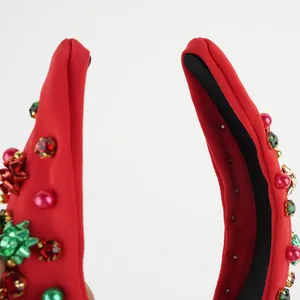 Red fabric Christmas headband with green beads, pearls and festive bow accents