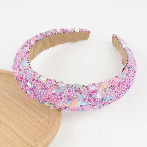 Detail of beaded padded headband with colorful sequins and soft velvet lining texture