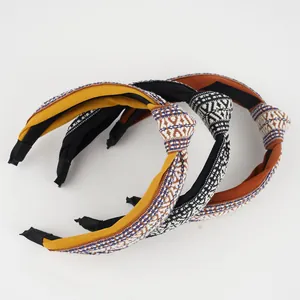 Detail view of knot headbands featuring ethnic embroidery and geometric weave patterns