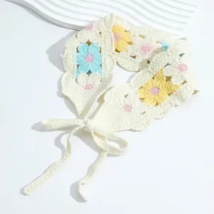 Detailed knit texture of handmade floral crochet headband with adjustable ties