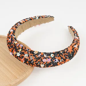 Macro detail of hand-beaded headband featuring colorful smiley faces and velvet lining