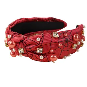 Halloween knot headband with red spider web fabric, pearls, and sparkling rhinestones