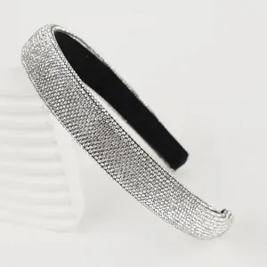 Close-up detail of a luxury wide silver rhinestone headband with soft sponge padding
